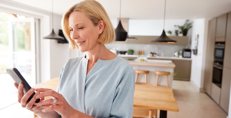 Resident using a cell phone in a modern home